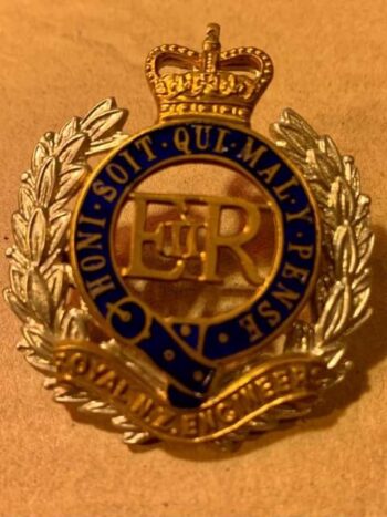 RNZE brass and enamel hat badge